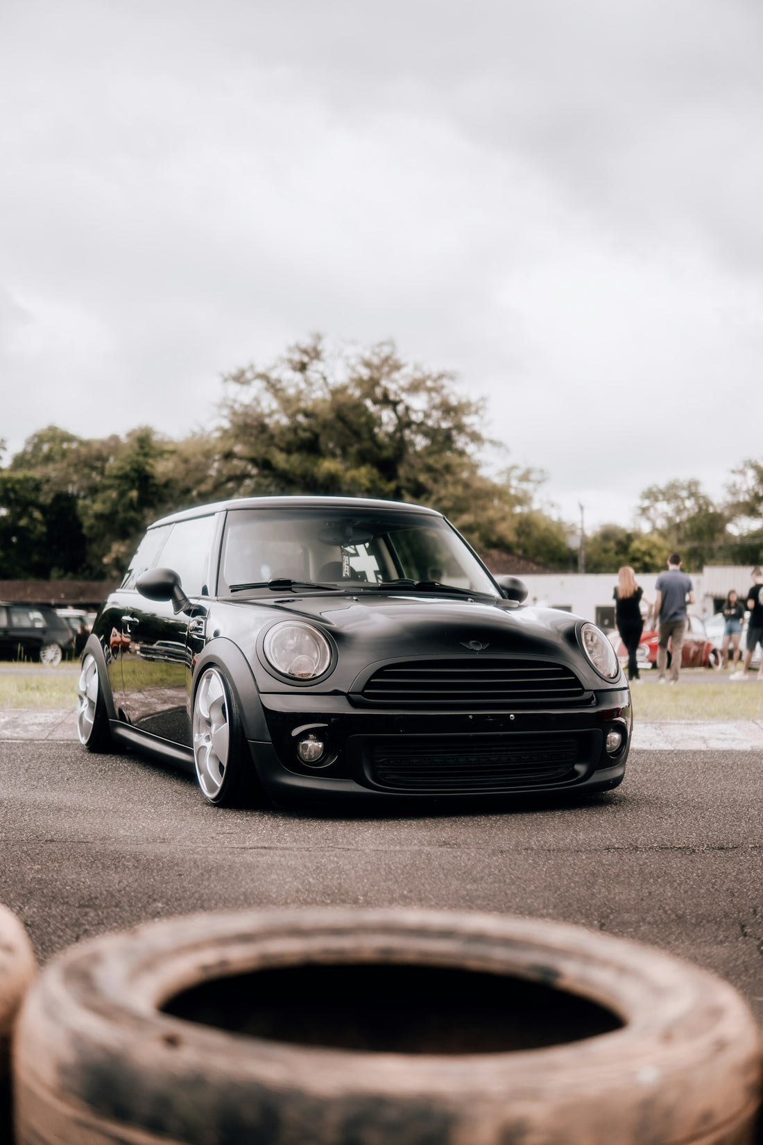 a small black car parked in a parking lot