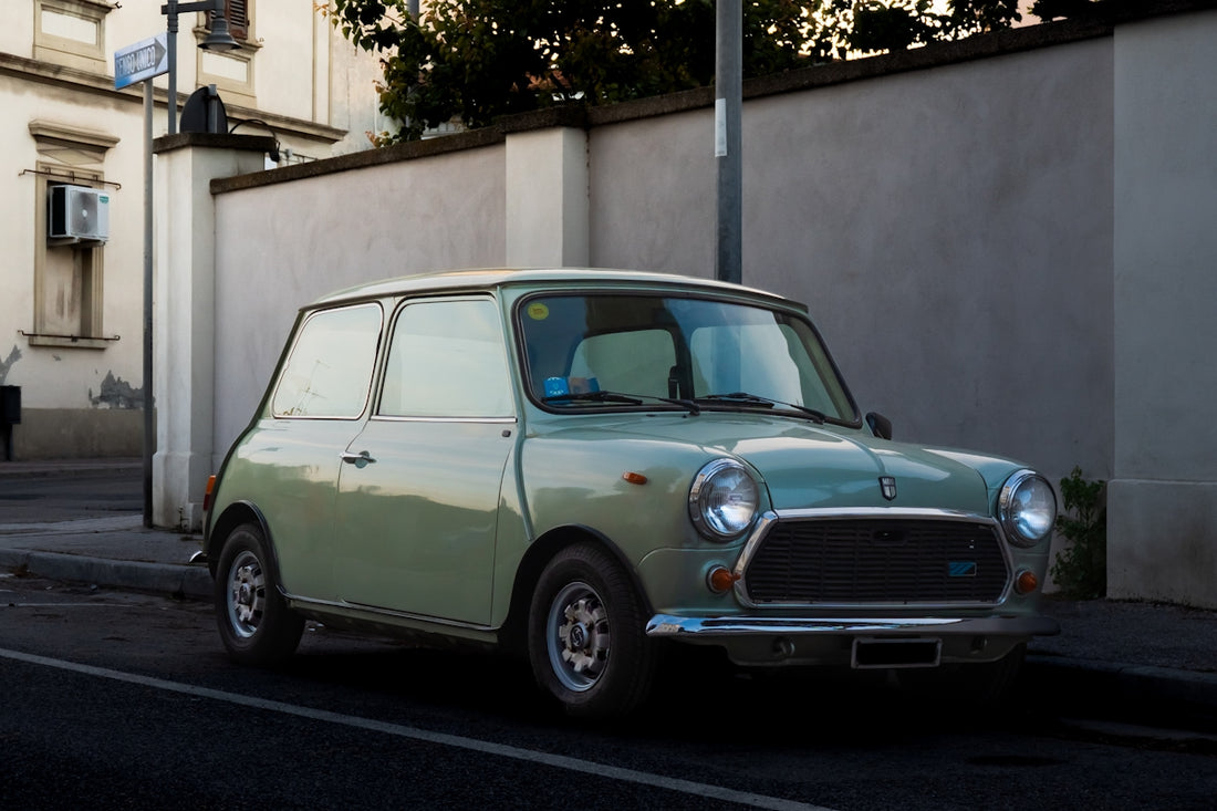 A light green vintage mini cooper parked on street